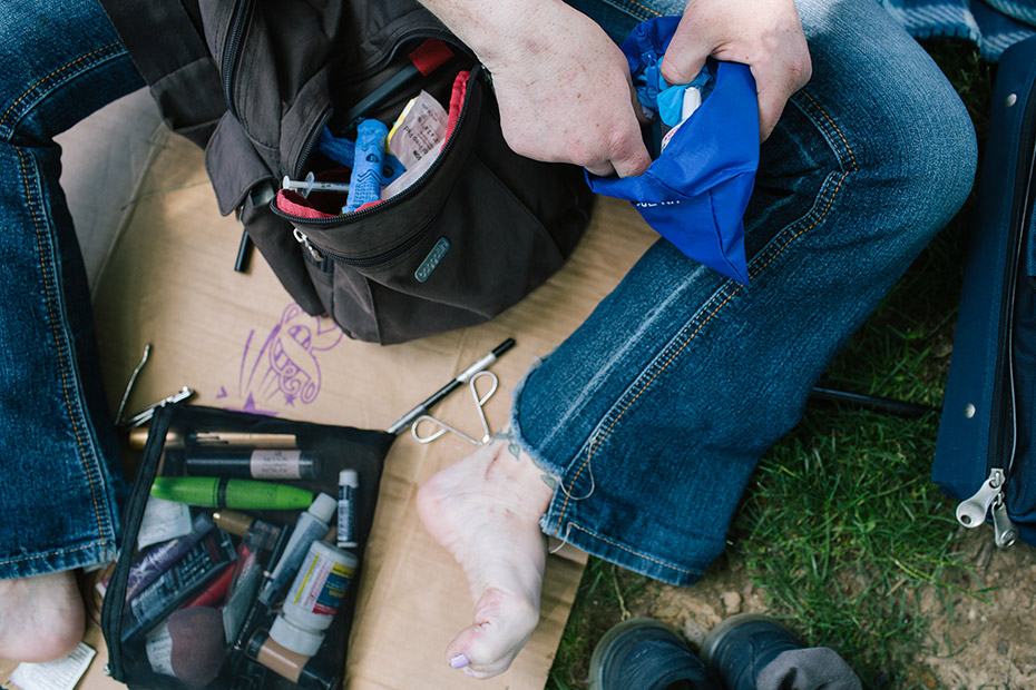 A woman opens an opioid overdose rescue kit in McPherson Square Park in Philadelphia.