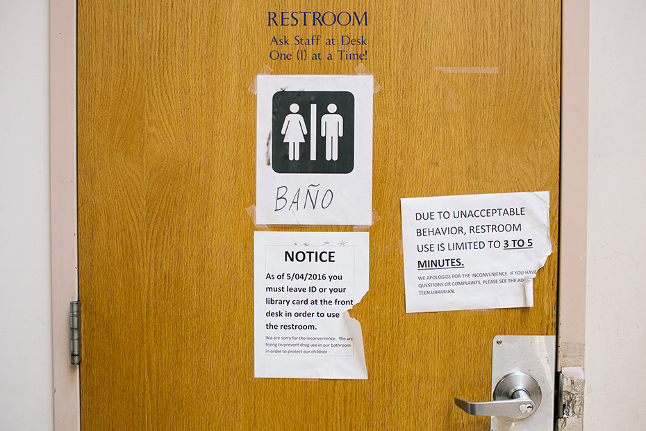 A notice data-on the bathroom door informs patrons of rules to use the bathroom at McPherson Square Library.