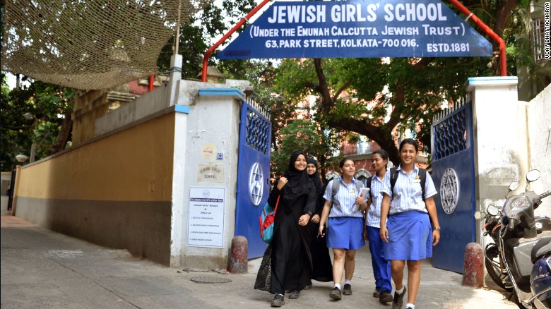 Muslim girls, some in the burqa and some in the regular uniforms, leave the Jewish Girls School in Calcutta.