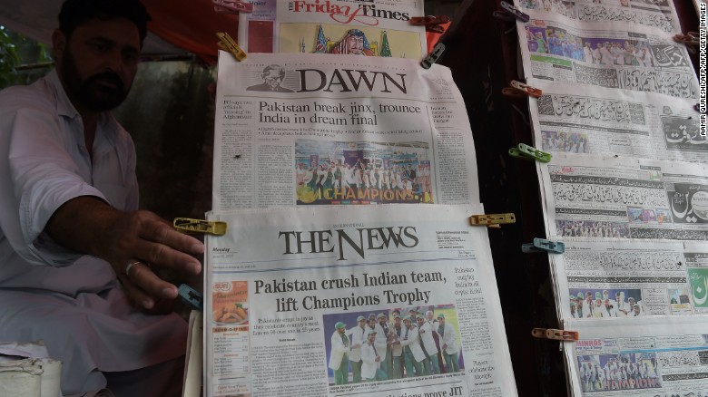 A Pakistani vendor arranges morning newspapers featuring front page coverage of Pakistan&#39;s victory against India in the ICC Champions Trophy final cricket match played in London, in Islamabad 