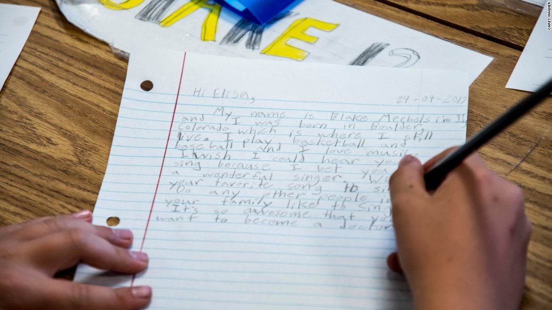 A student, Blake Mechels, writes a letter to student Elisa in Dadaab Refugee Camp.