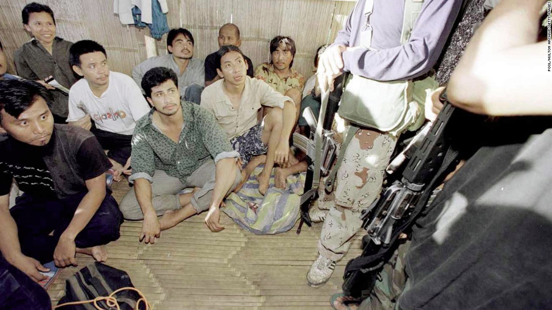 Malaysian hostages are guarded by two ASG militants in 2000.