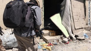 The body of an ISIS fighter lies in a doorway in the Old City.