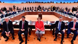 TOPSHOT - (L-R) US President Donald Trump, China&#39;s President Xi Jinping, German Chancellor Angela Merkel, Argentinia&#39;s President Mauricio Macri and Australia&#39;s Prime Minister Malcolm Turnbull turn around for photographers at the start of the first working session of the G20 meeting in Hamburg, northern Germany, on July 7.
Leaders of the world&#39;s top economies will gather from July 7 to 8, 2017 in Germany for likely the stormiest G20 summit in years, with disagreements ranging from wars to climate change and global trade. / AFP PHOTO / AFP PHOTO AND POOL / John MACDOUGALL        (Photo credit should read JOHN MACDOUGALL/AFP/Getty Images)