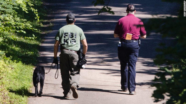 Investigators with dogs search Solebury for four missing men.