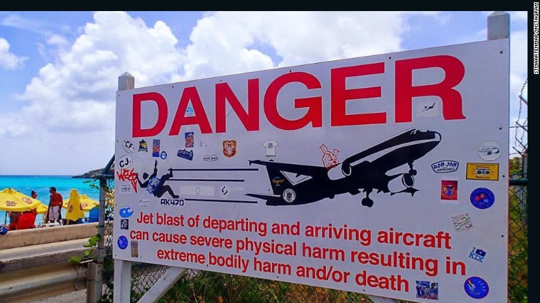 A sign near St. Maarten&#39;s Princess Juliana International Airport warns people about the danger from airplane jet engines.