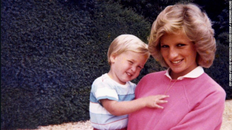 Diana, Princess of Wales, holding Prince William while pregnant with Prince Harry.