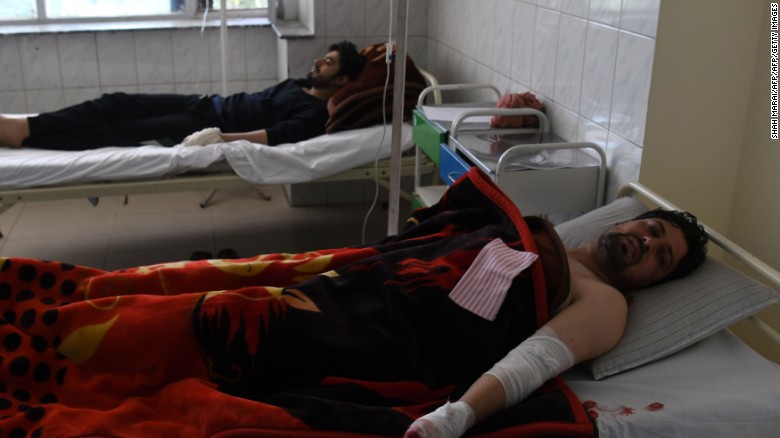 Afghan men rest in a hospital after being injured in a car bomb attack in Kabul on July 24, 2017.