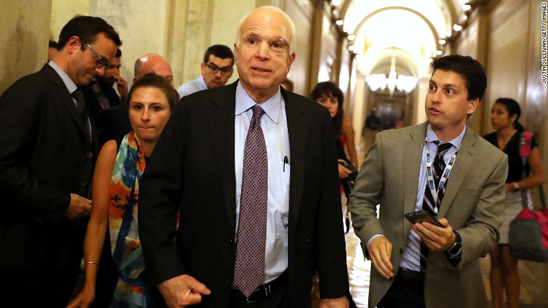 Senator John McCain speaks with reporters after voting "no"