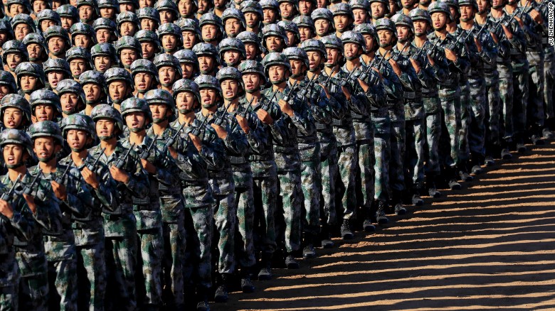 Chinese troops march in formation on Sunday. 