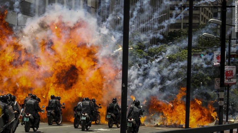 Members of the Bolivarian National Police are caught in an explosion as they ride motorcycles near Altamira Square in Caracas, Venezuela, on Sunday, July 30. Police and protesters clashed during a controversial vote to elect a special assembly that would rewrite the constitution. At least six people -- including two teenagers -- &lt;a href=&quot;http://www.cnn.com/2017/07/30/americas/venezuela-on-edge-vote/index.html&quot; target=&quot;_blank&quot;&gt;were killed during protests,&lt;/a&gt; and a National Guard officer was also reported dead by the Attorney General&#39;s Office.