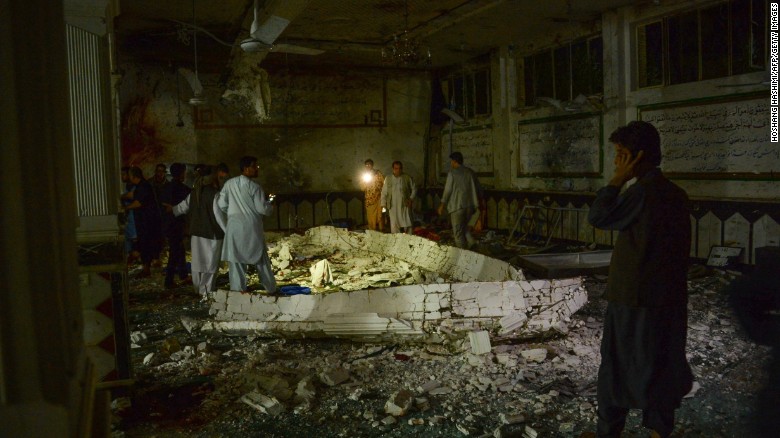 Afghan security personel inspect the site of a suicide bomb attack Tuesday at a Shiite mosque in Herat.