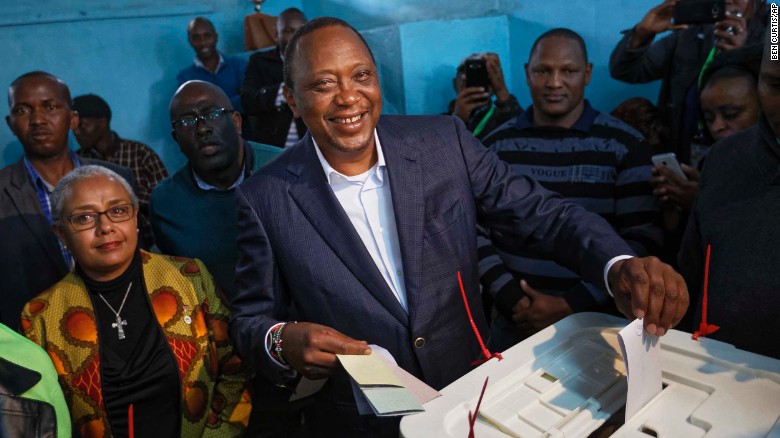 Kenyatta casts his vote alongside his wife Margaret on Tuesday. 