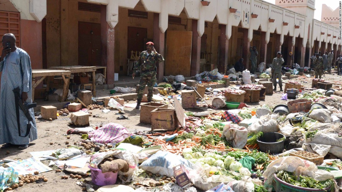Soldiers stand guard at a market in N&#39;Djamena, Chad, following a suicide bomb attack on July 11, 2015. At least 14 people were killed when a man dressed as a woman detonated his explosives in a crowded market in the city.