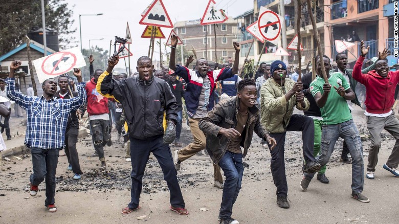 Opposition demonstrators carrying road signs shout and gesture in the Mathare slums of Nairobi on Wednesday. Odinga&#39;s hacking claims have ratched up tensions in his strongholds.