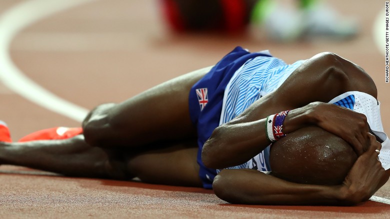 Britain&#39;s Mo Farah slumps to the track in disappointment after failing in his bid for gold in the 5,000m at the world athletics championship in London. 