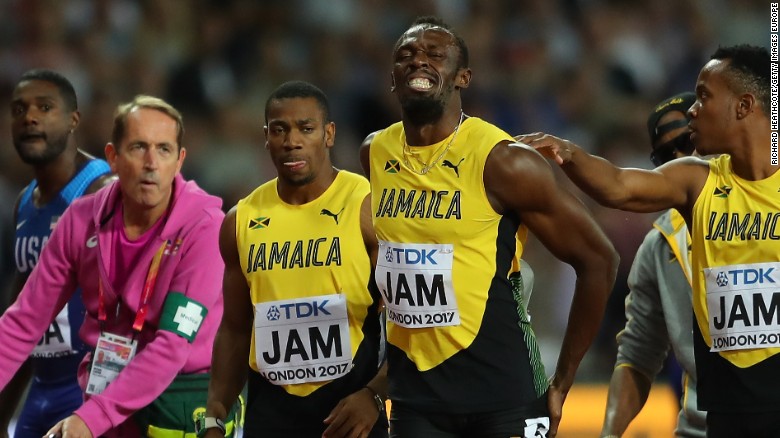The agony is clear for all to see as Bolt is comforted by Jamaican teammates. 