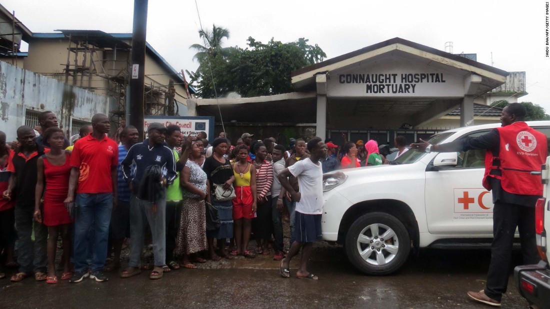 Emergency personnel gather outside the morgue at Freetown&#39;s Connaught hospital.