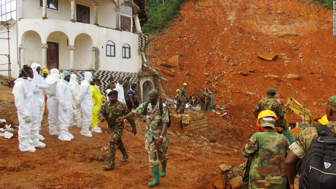 Rescue teams assess the damage near Freetown on Tuesday. 