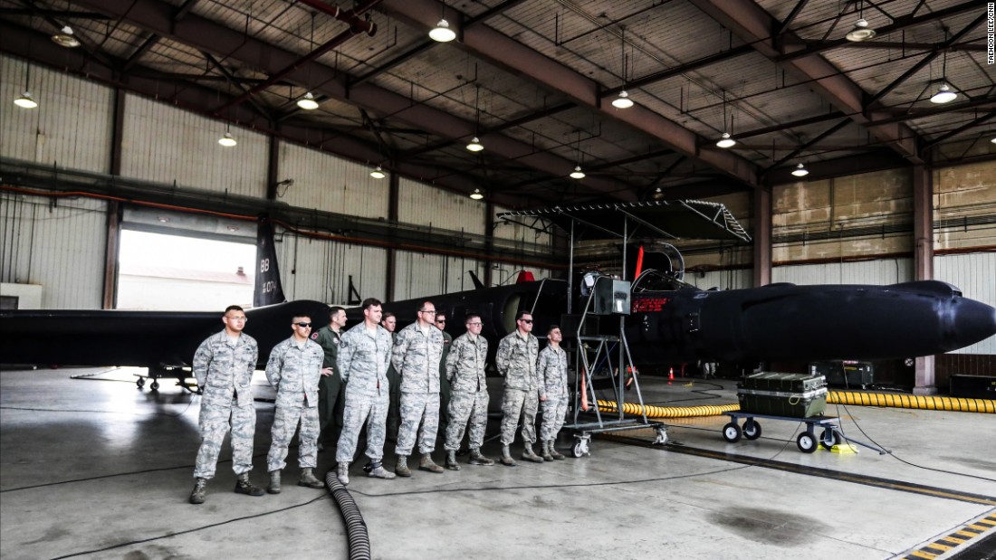 US Air Force crew stand in front of a U-2 spy plane at Osan Air Base, South Korea.