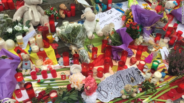 Candles,flowers, toys and messages of solidarity are left at a makeshift memorial on Las Ramblas.