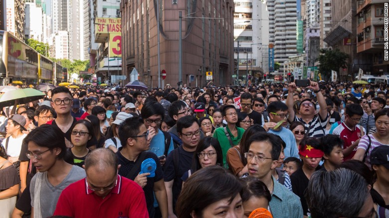 Thousands of protestors march through Wanchai district in support of the three men, who were jailed last week after being convicted of unlawful assembly.