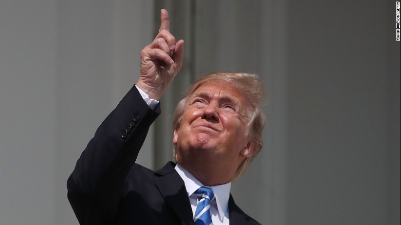 President Donald Trump looks up toward the Solar Eclipse on the Truman Balcony at the White House on August 21, 2017.