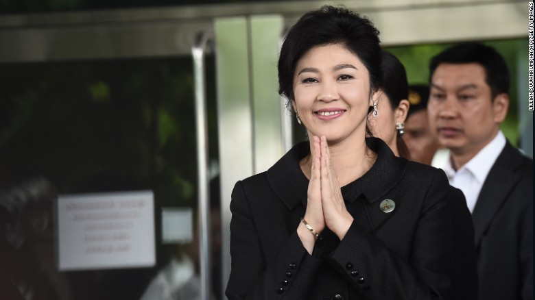 Yingluck Shinawatra greets supporters as she leaves the Supreme Court on July 21.