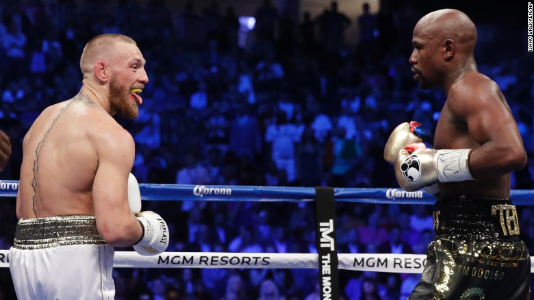 McGregor sticks his tongue out at Mayweather during an early exchange.