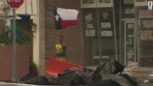 Symbol of hope: Resident waves Texas flag 