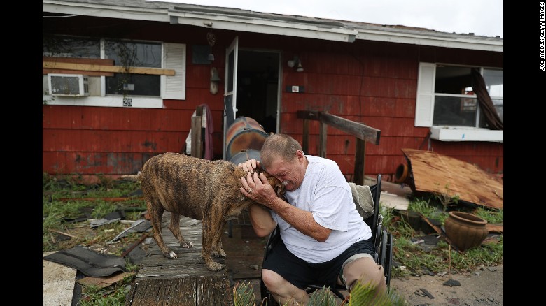 Steve Culver cries with his dog Otis as he talks about the &quot;most terrifying event in his life,&quot; when Hurricane Harvey destroyed most of his home while he and his wife took shelter there on August 26, 2017 in Rockport, Texas.