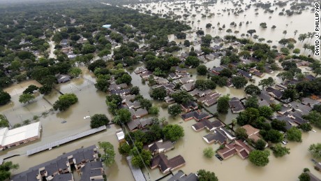 Water from the Addicks Reservoir in Houston flows into neighborhoods as floodwaters rise on Tuesday, August 29.