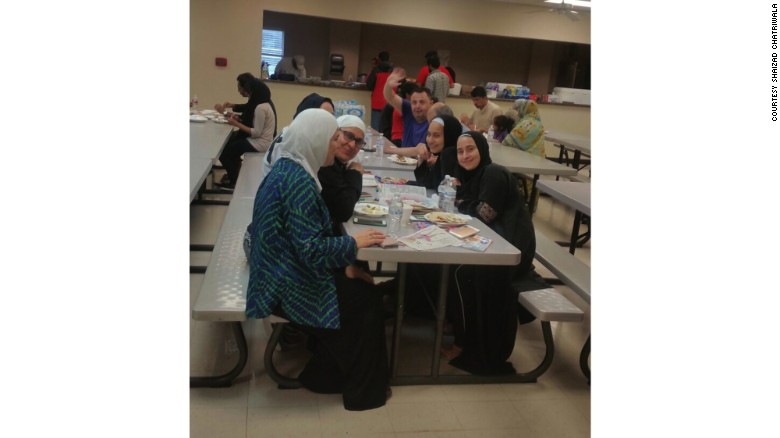 Evacuees eat at the Brand Lane Islamic Center in Stafford, Texas.