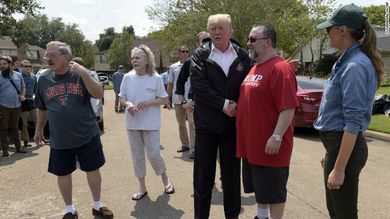 PresidentDonald Trump and first lady Melania Trump talk with people impacted by Hurricane Harvey in a Houston neighborhood on Saturday.