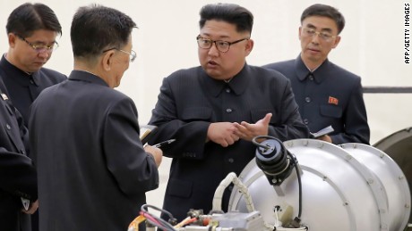 This undated picture released by North Korea&#39;s official Korean Central News Agency (KCNA) on September 3, 2017 shows North Korean leader Kim Jong Un, center, looking at a metal casing with two bulges at an undisclosed location. 