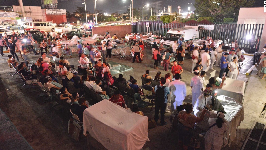 Medical staff and patients wait outside after a hospital was evacuated in Villahermosa, Mexico.