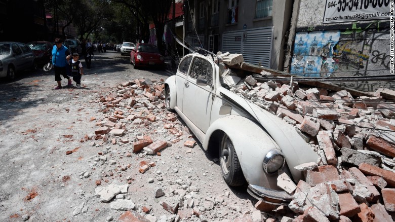 A car is crushed by debris in Mexico City on September 19.