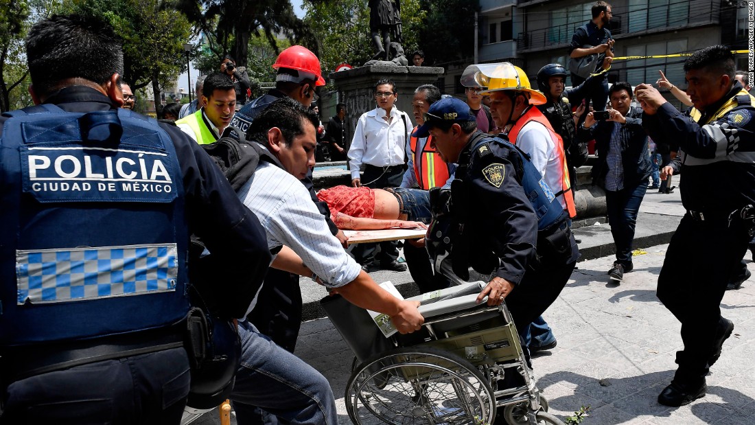 A woman receives medical assistance after she was injured in Mexico City on September 19.