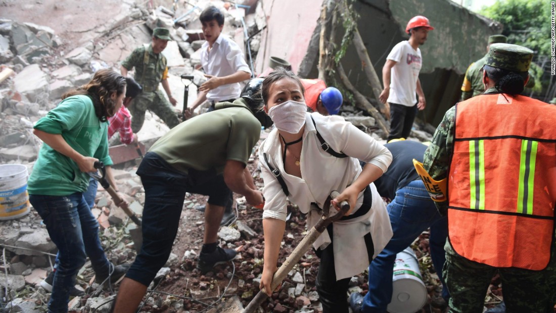 Emergency workers remove debris as they search for survivors in Mexico City on September 19.