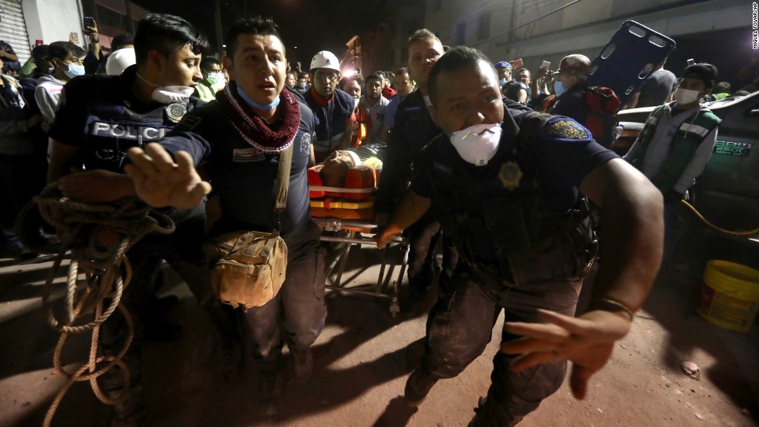 An injured person is carried away after being rescued in Mexico City on Tuesday, September 19.
