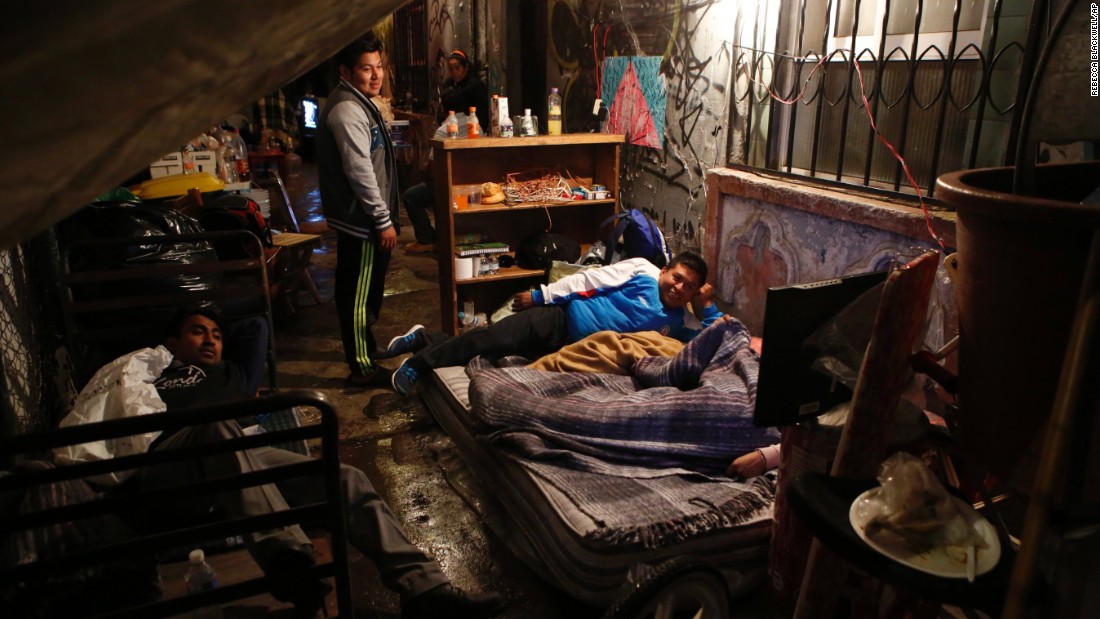 Five families prepare to sleep under tarps on the sidewalk outside their earthquake damaged building in the Roma neighborhood of Mexico City, September 20. 