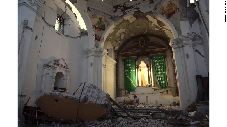 Chunks of fallen masonry lie by an altar in Santiago the Apostle Catholic Church.