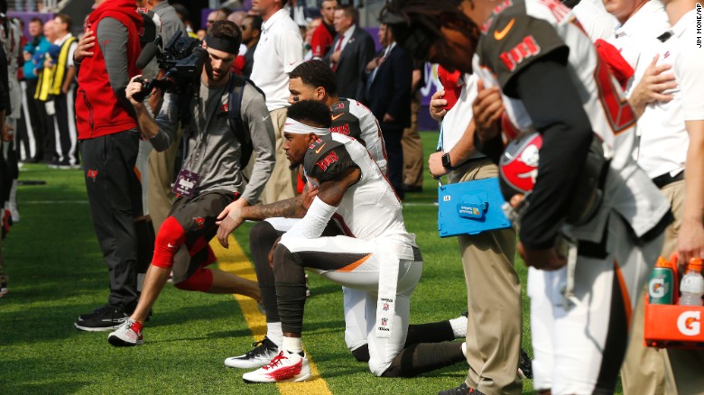 Wide receivers DeSean Jackson, forefront, and Mike Evans take a knee before Sunday&#39;s game.