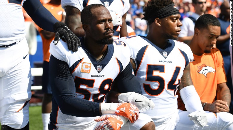 Denver Broncos Von Miller, left, and Brandon Marshall  take a knee during the anthem before their game.