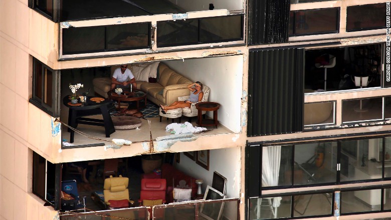 An apartment building is missing a wall in San Juan, Puerto Rico, on Monday, September 25, nearly a week after Hurricane Maria devastated the US commonwealth. Power is still out in most places, and communications remain almost nonexistent on the island of 3.4 million people. 