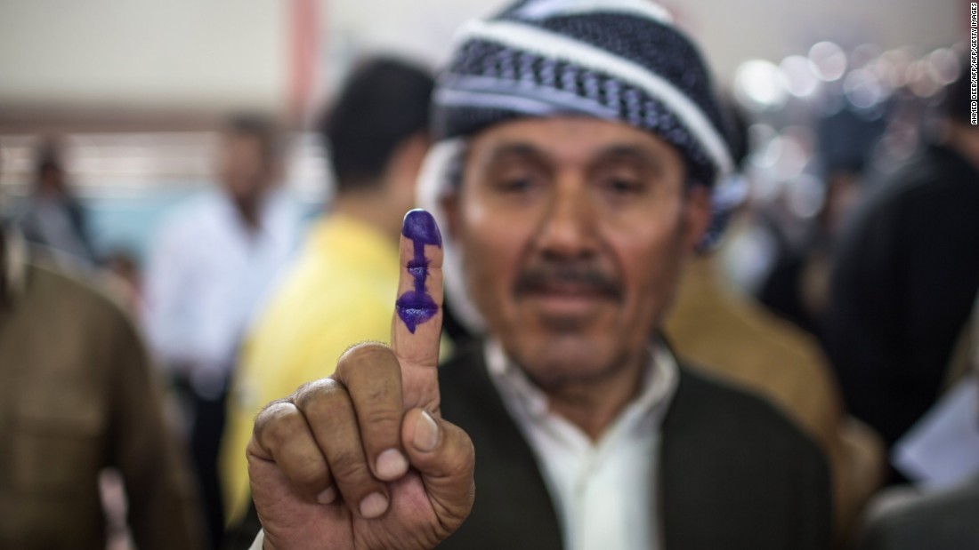 An Iraqi Kurdish man shows his ink-stained finger after voting in the Kurdish independence referendum. 