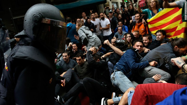 Spanish National Police clash with pro-independence supporters in Barcelona on October 1, 2017, the day of the vote.