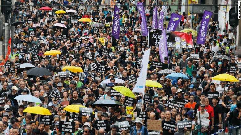 Protesters march in Hong Kong on Sunday, October 1, 2017.