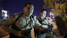 Police officers advise people to take cover in the wake of the shooting.