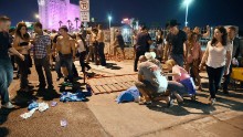People tend to a victim at the festival grounds.